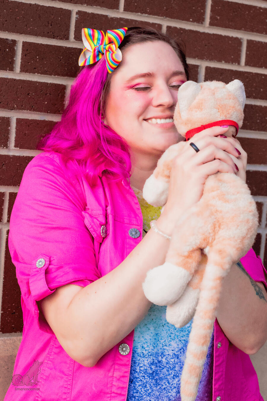 Photo of Erika Gritton holding her childhood cat plushie, Spice.